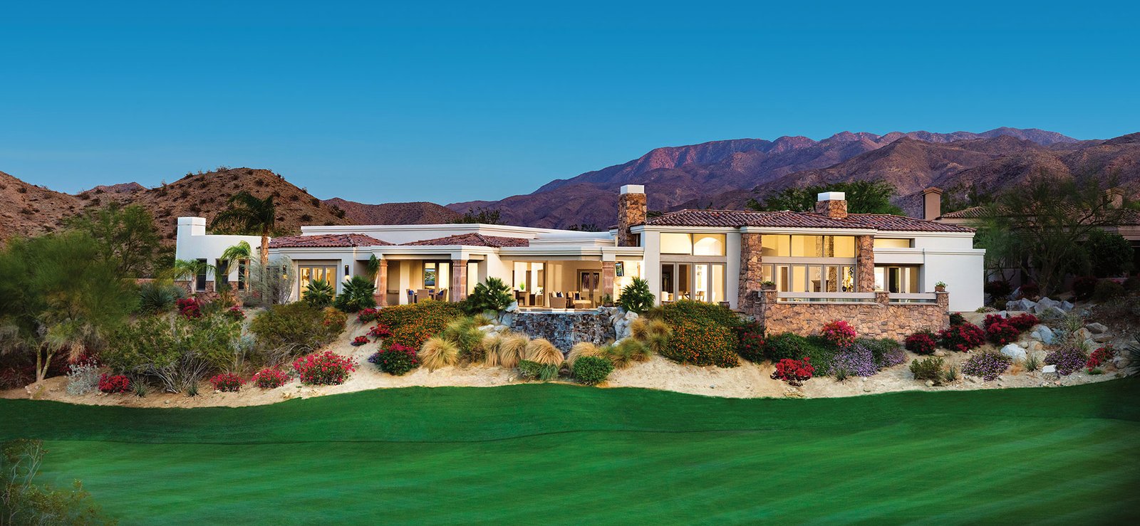 Luxury golf course home at BIGHORN Golf Club in Palm Desert, California, with dramatic mountain views and desert landscaping.