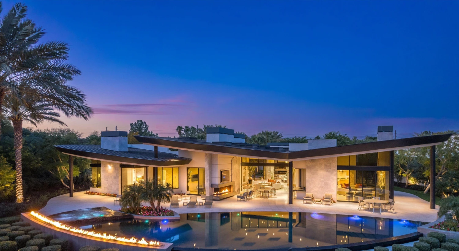 Contemporary luxury home in Indian Wells featuring modern architecture, expansive outdoor living, a swimming pool and fire features.