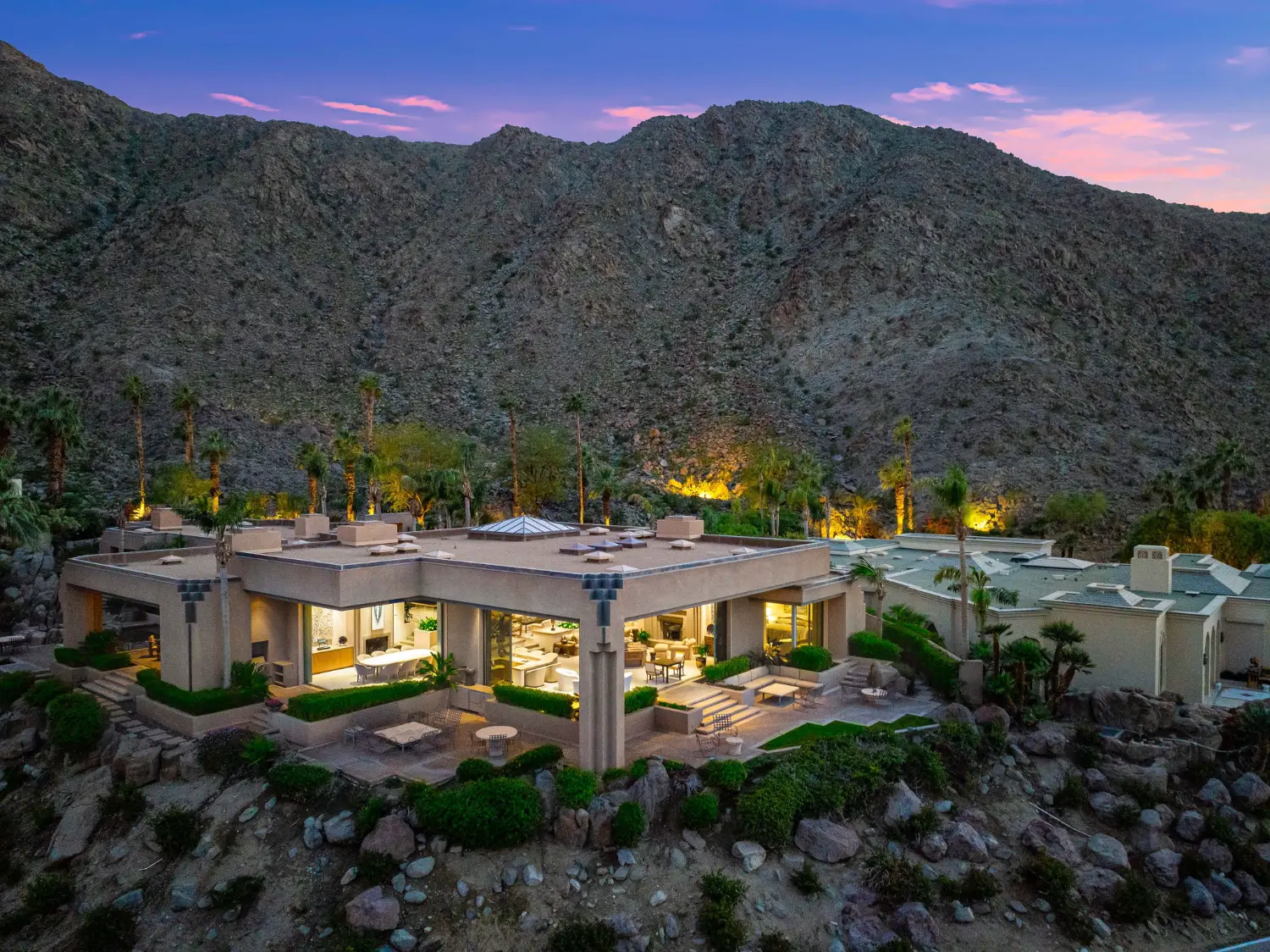 Luxury home at The Vintage Club in Indian Wells, California, set against the dramatic Santa Rosa Mountains at sunset.